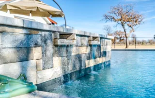 Luxury custom swimming pool and integrated raised spa design by Redfin Pools